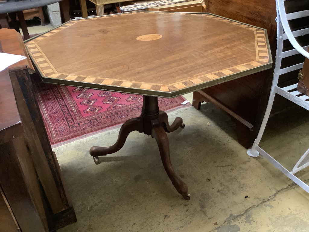 Two similar George III parquetry inlaid mahogany octagonal tilt top tables, width 96cm, height 73cm